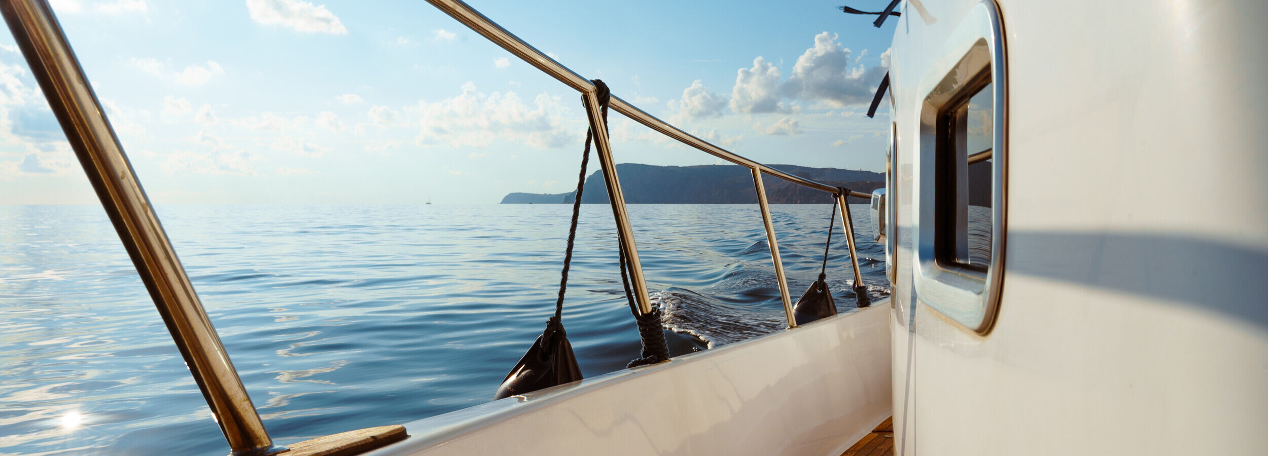 deck-of-white-yacht-sailing